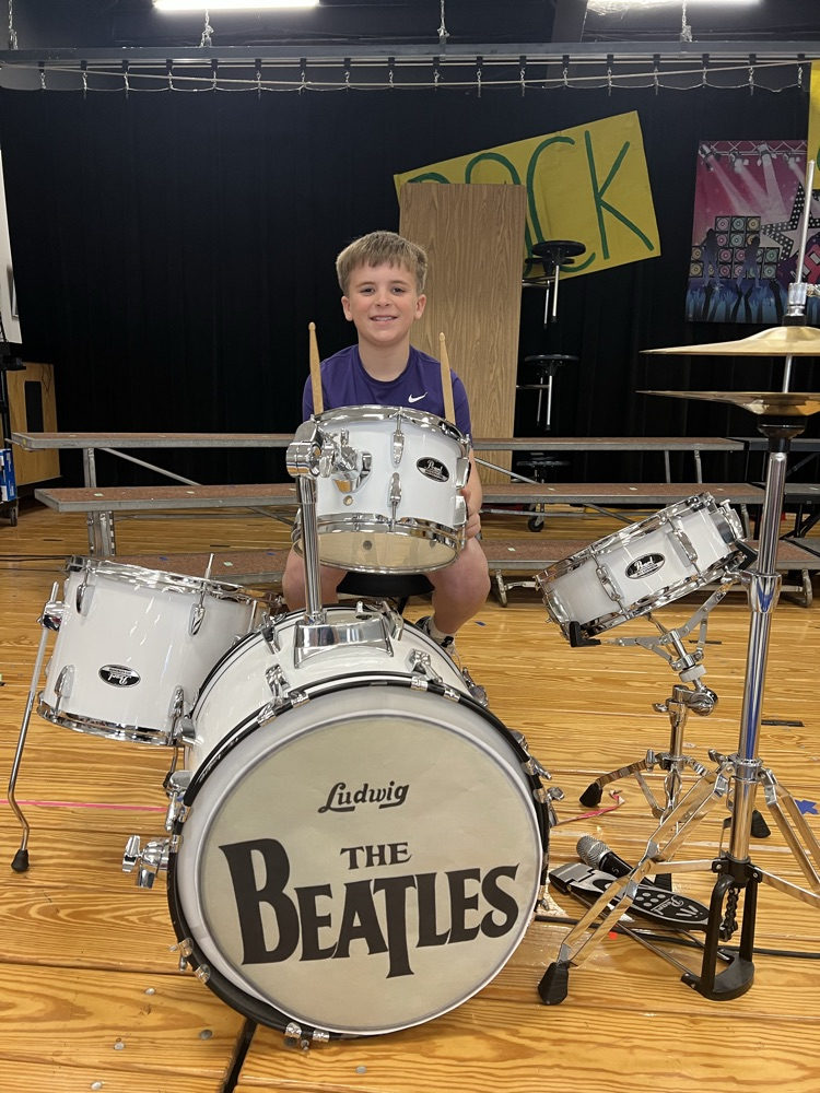student playing the drums on stage