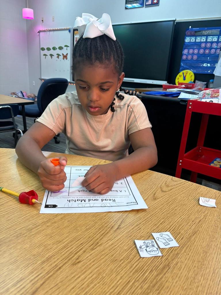 student working on cut and paste