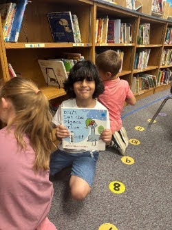 Students looking at books on the library shelves