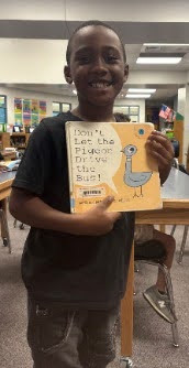 student posting with the book titled Don't Let the Pigeon Drive the Bus