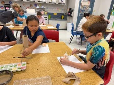 students painting with water color