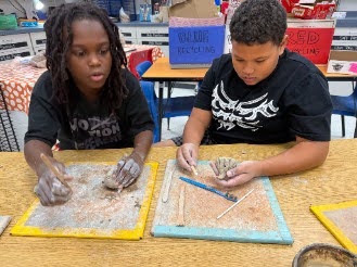 students sculpting with clay