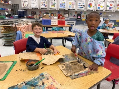 students painting with water colors