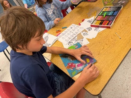 student working with oil pastels