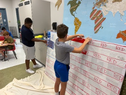 students working on the american flag mural