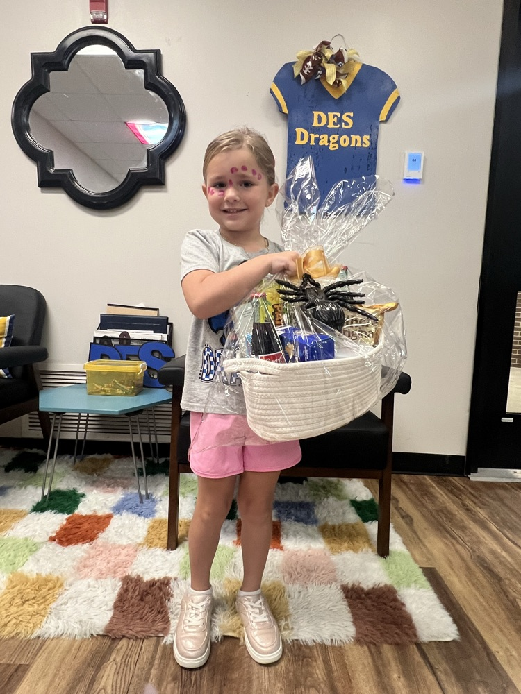 reading challenge winner holding gift basket