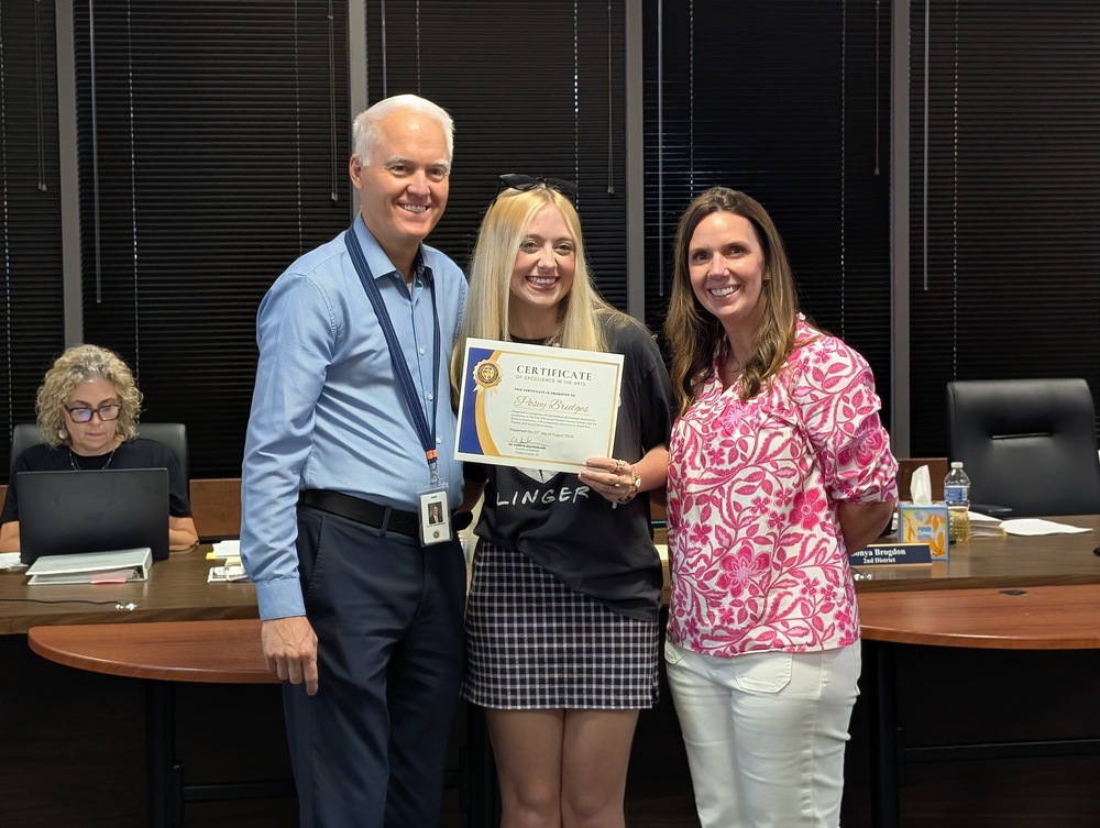 Posey Bridges being recognized for her accomplishments with  Curtis Southerland and Dr. Misty Marvin