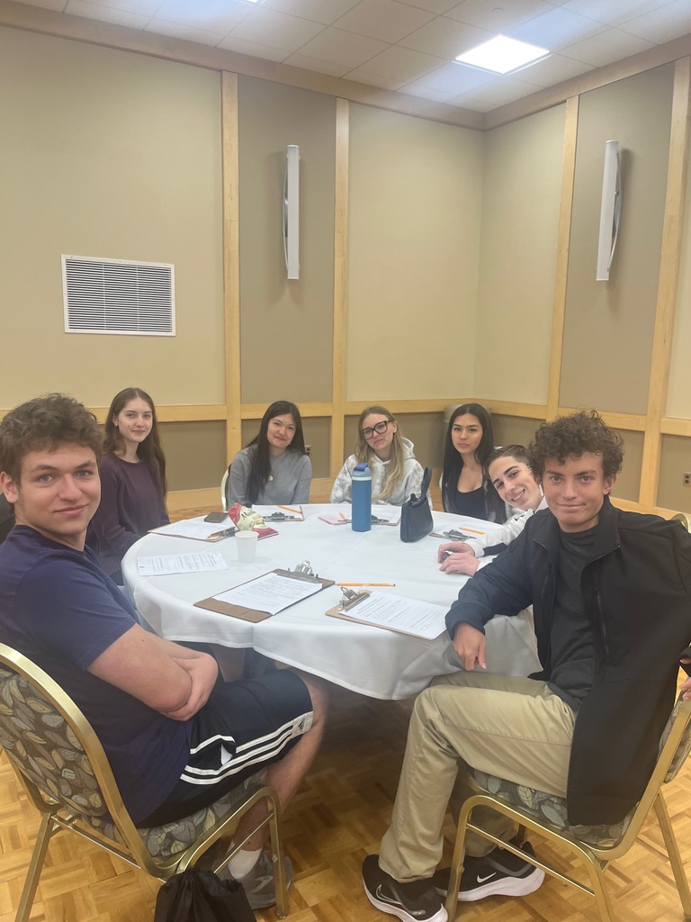 students at a conference table