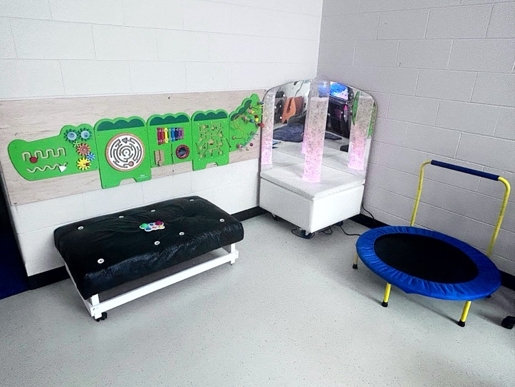 A bubble machine with mirrors, an activity alligator and a trampoline.