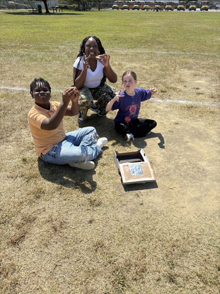 students testing solar ovens 