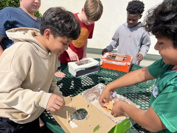 students testing solar ovens 