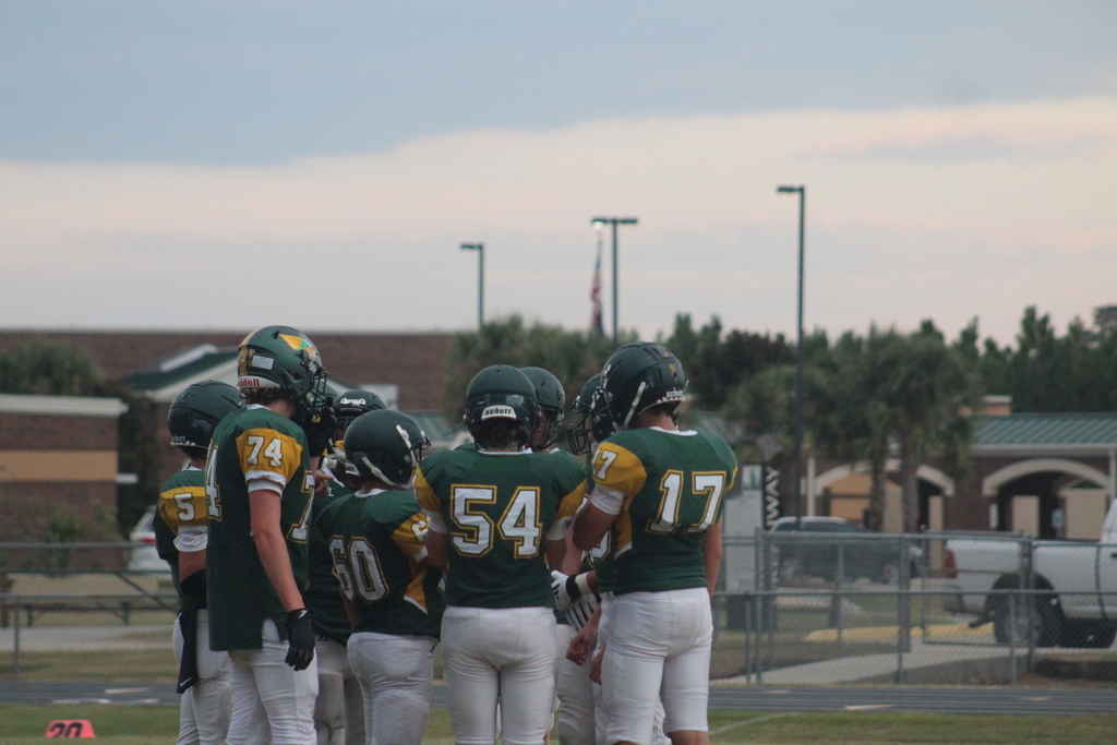Football players in huddle