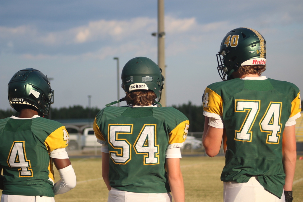 Latta football players on sidelines.