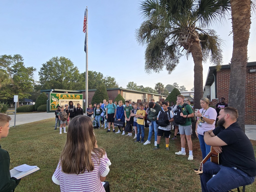 Students gather around the pole. 