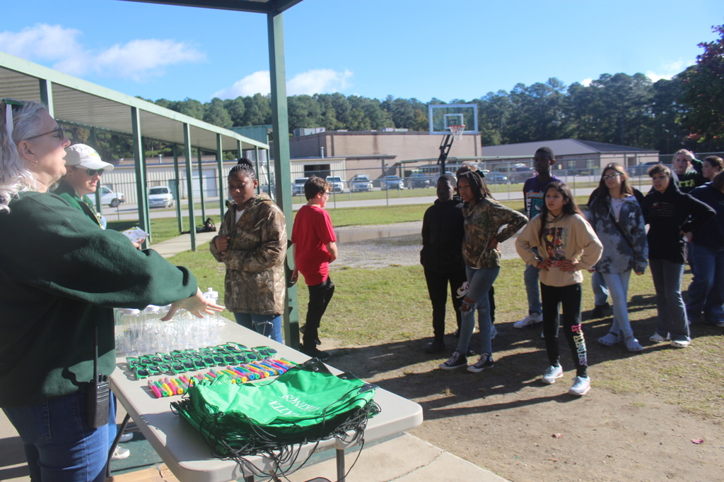 Students line up to receive swag items.