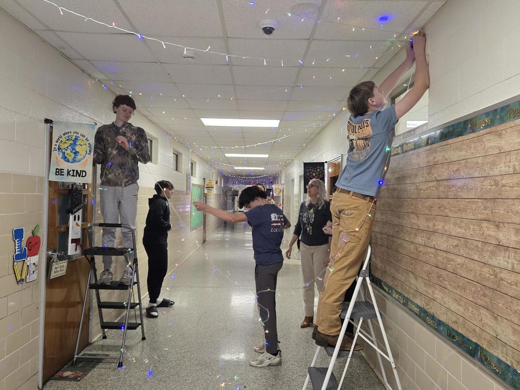 Students work to string lights.