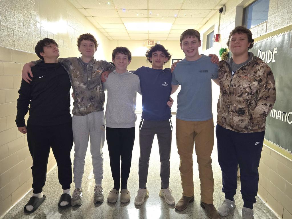 Group photo of students who string lights in the hall.