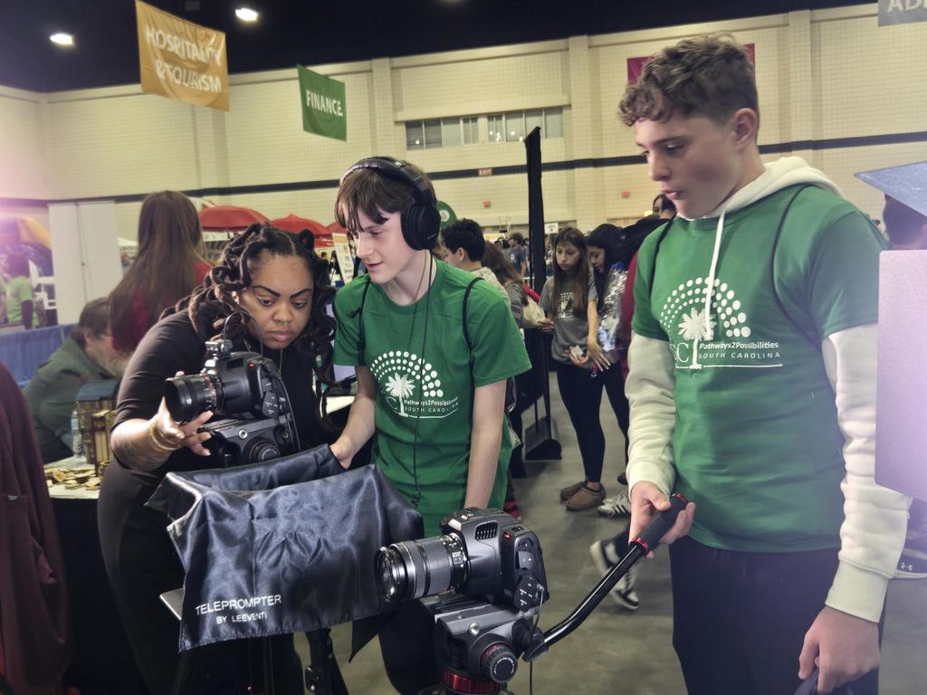 Students used equipment to film a podcast simulation.