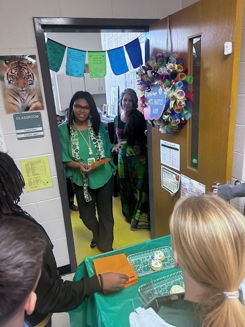 students handing out cookies