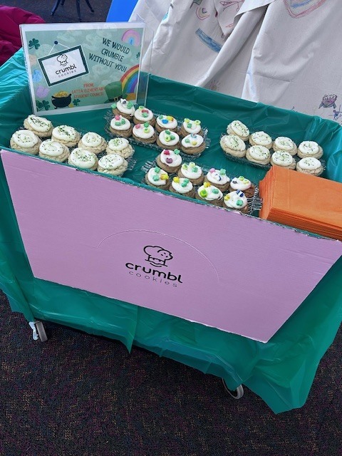 students handing out cookies