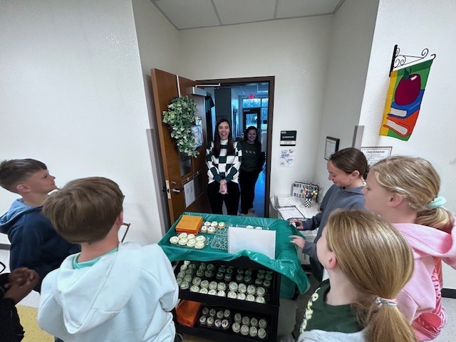 students handing out cookies