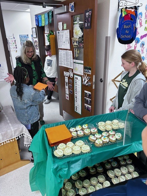 students handing out cookies