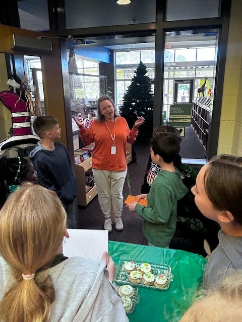 students handing out cookies