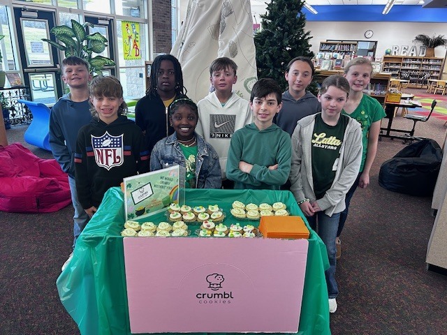 students handing out cookies