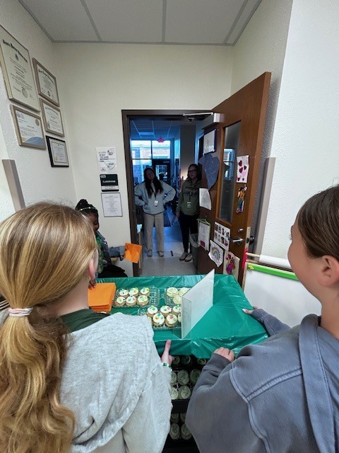 students handing out cookies