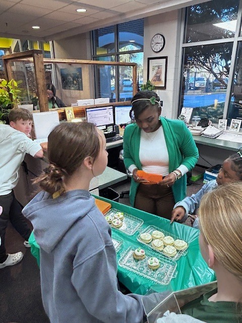 students handing out cookies