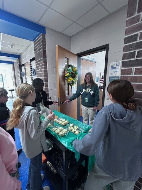 students handing out cookies