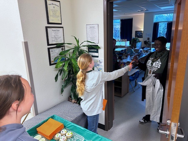 students handing out cookies