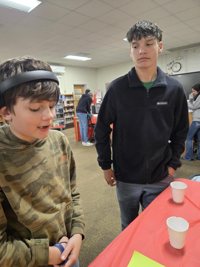 Students attempt to recite a nursery rhyme while holding jelly beans in their mouths to simulate speech impairments.