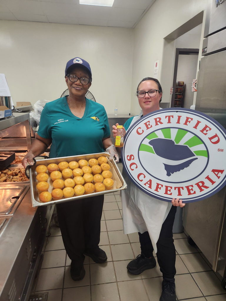 Cafeteria workers pictured with muffins drizzled with honey