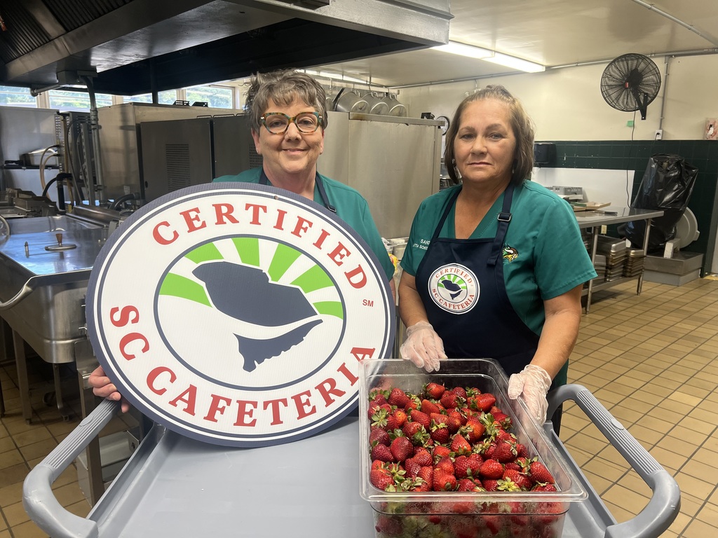 Cafeteria workers preparing strawberries 
