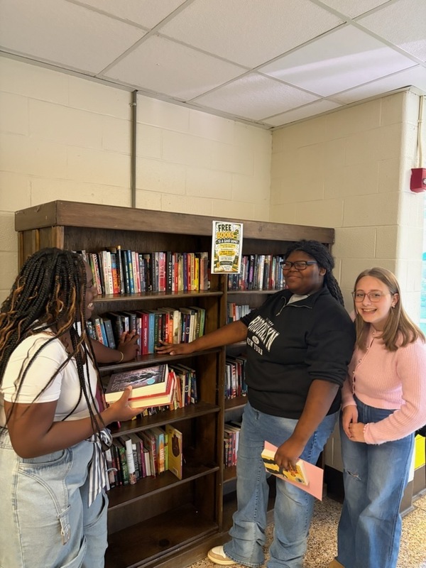 Students looking at free books on display