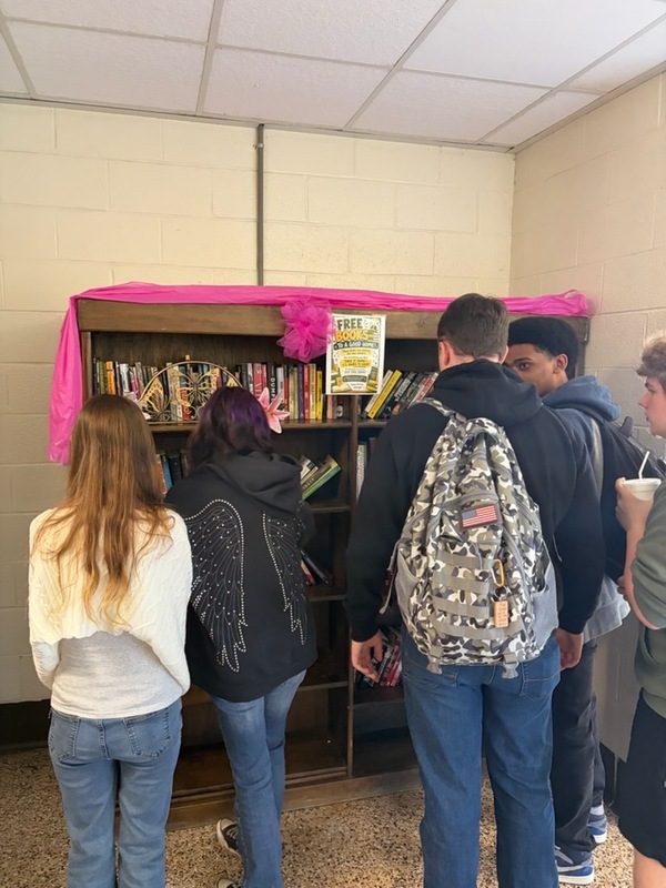 Students looking at free books on display.