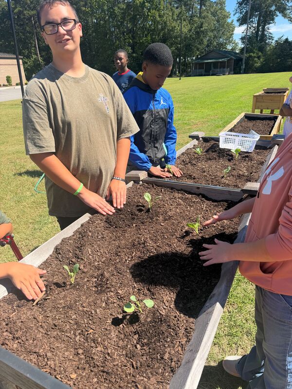 Students planting the raised garden beds at LMS