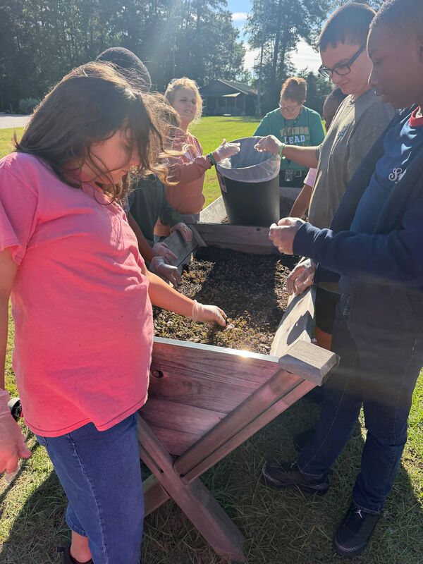 Students planting the raised garden beds at LMS