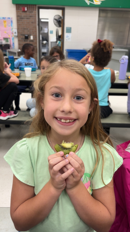 Student at LES trying new fruit