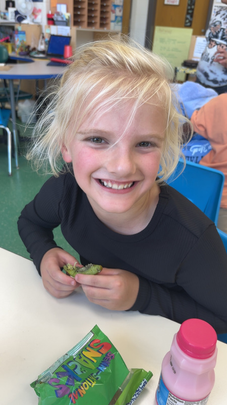 Student at LES trying new fruit