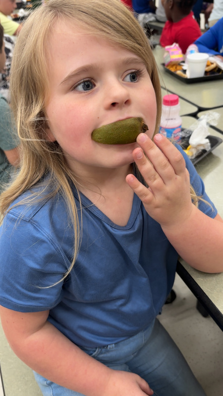Student at LES trying new fruit