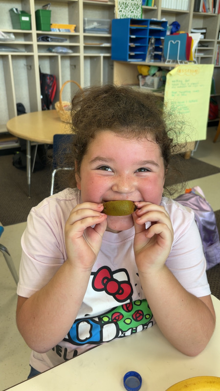 Student at LES trying new fruit