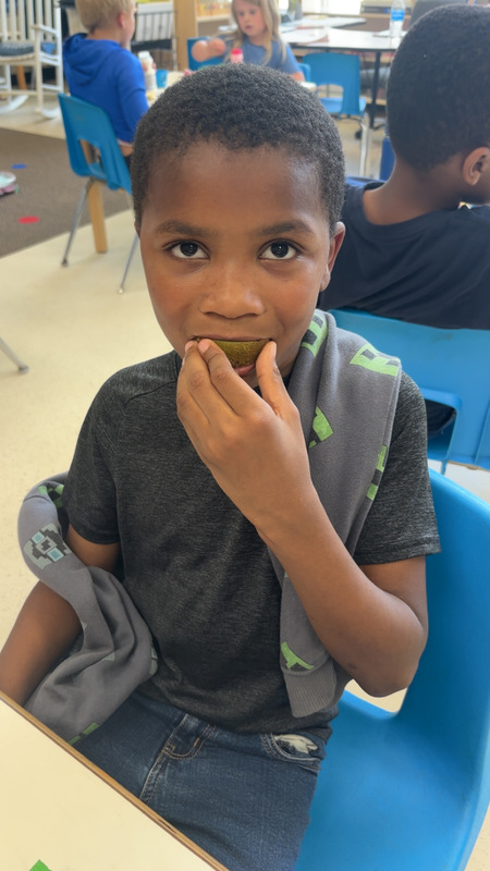 Student at LES trying new fruit