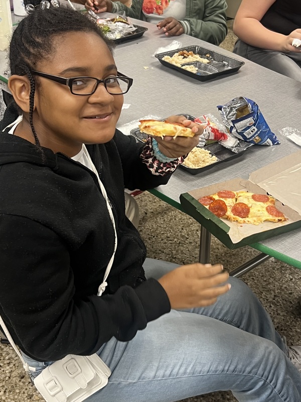 Student trying new pizza