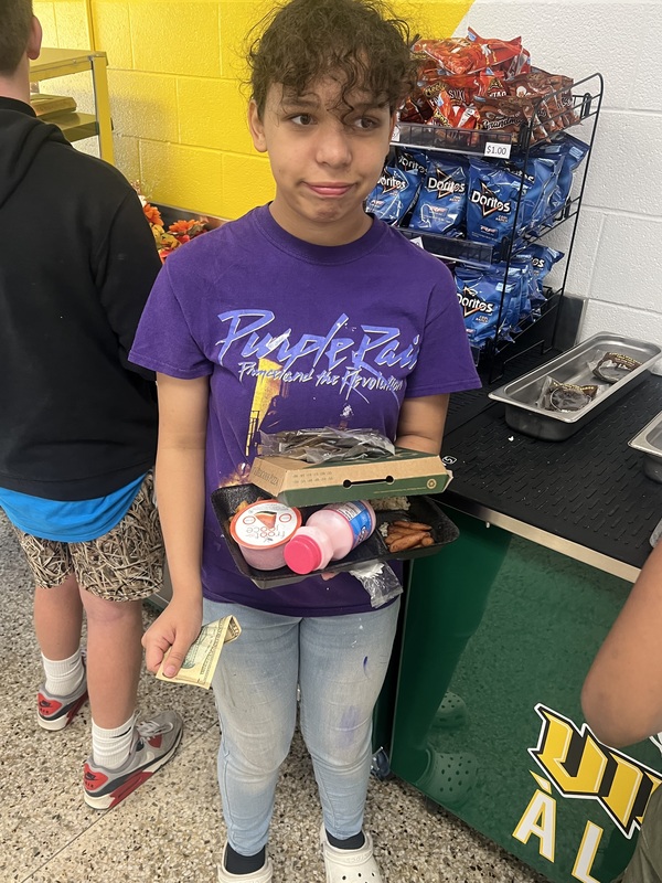 Student buying new pizza