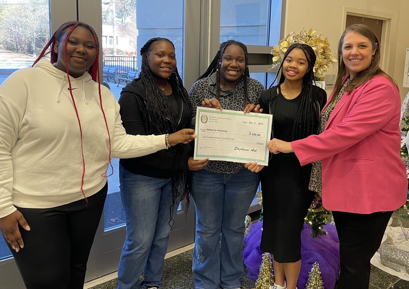 LHS/LMS Girl Talk group with donation check for Habitat for Humanity