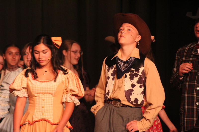 Students perform on stage