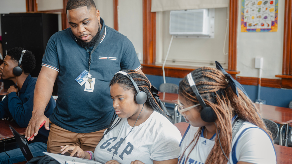 Students collaborating with teacher