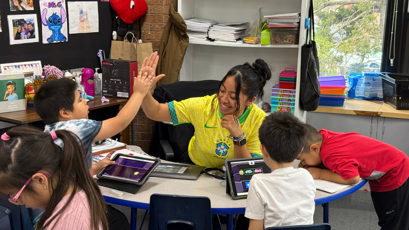 Teacher celebrating a student